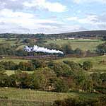 2392 passing Green End with four teak coaches